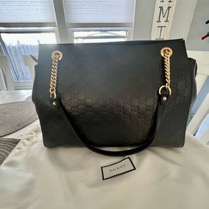 Brand new leather Gucci bag with gold accents.